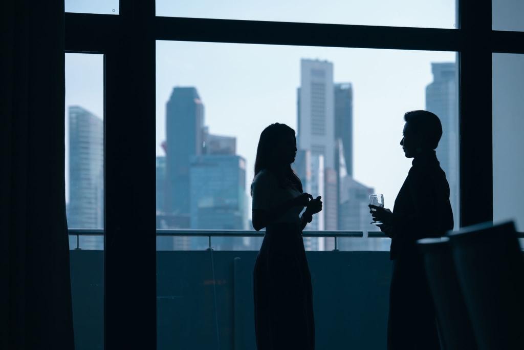 Business professionals silhouetted against city skyline